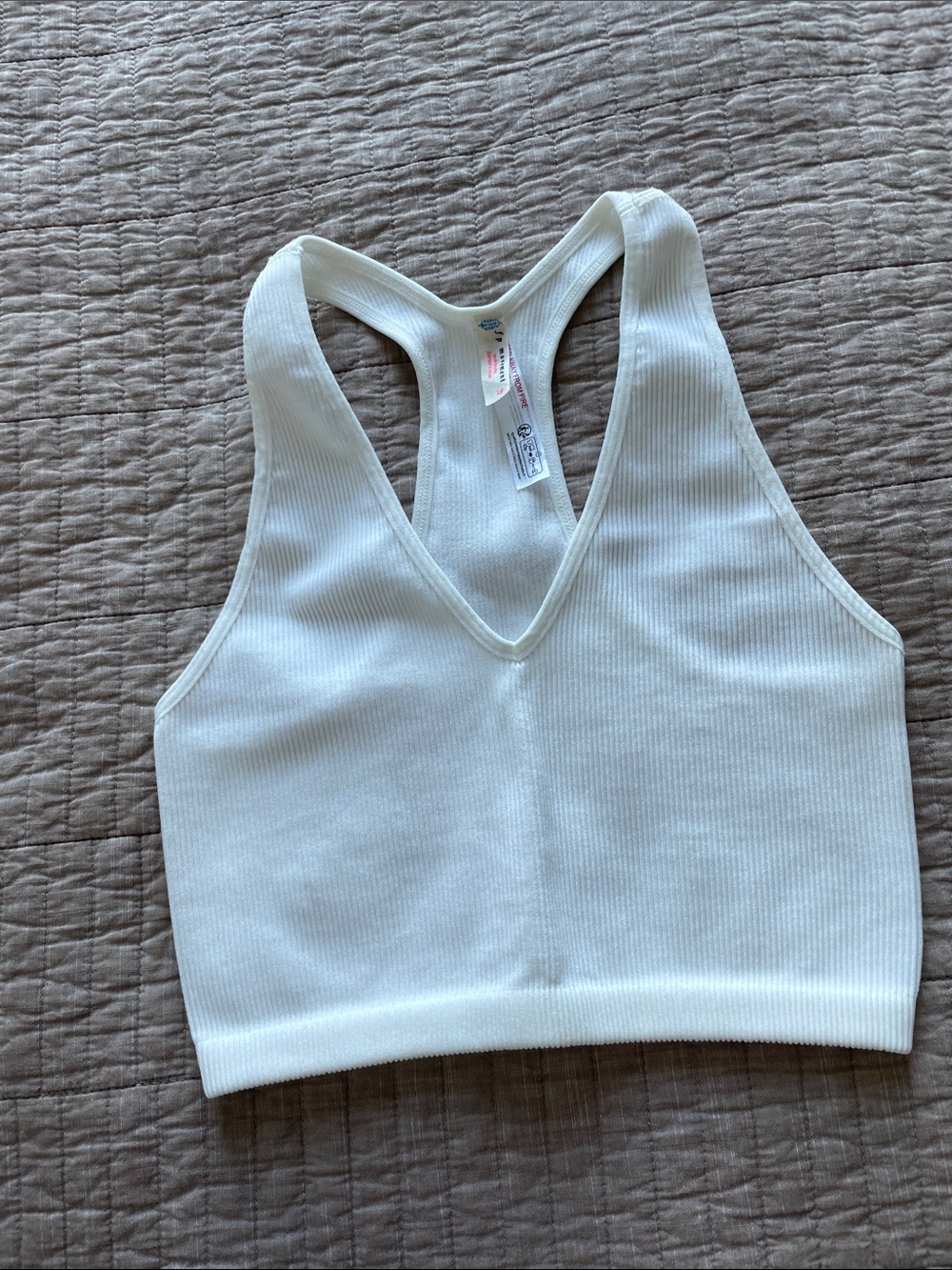 FP Movement by Free People White Ribbed Racerback Tank stretching